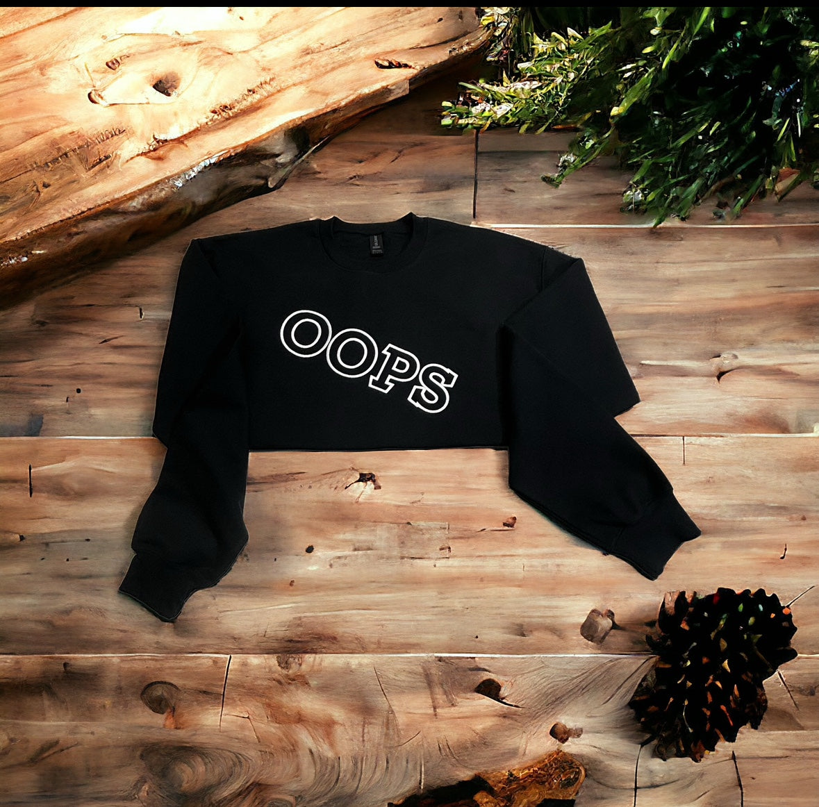 Black OOPS sweatshirt with white outlined lettering